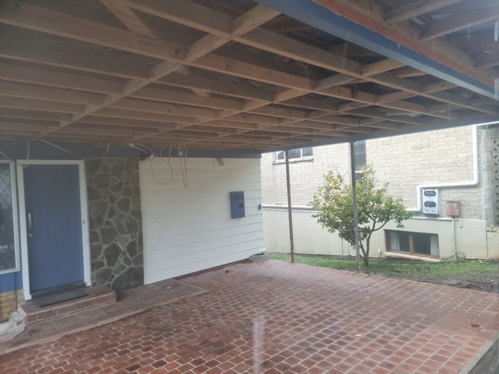 Carport ceiling with exposed beams post asbestos fibre cement ceiling removal - outside.