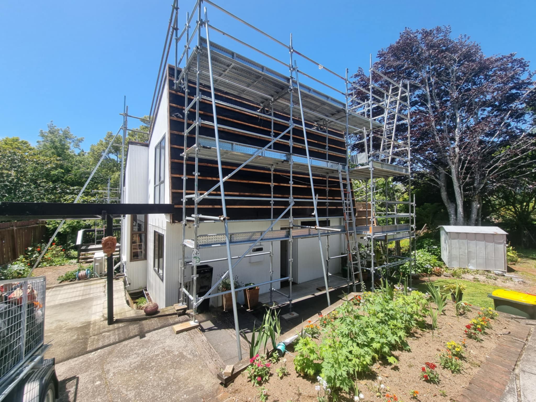 Scaffolding and sealed containment area for asbestos cladding removal project.