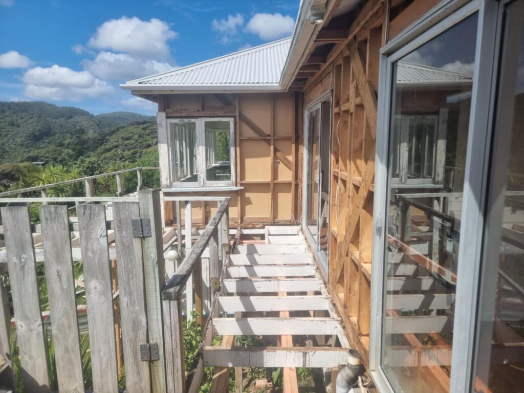 Residential house and deck after removal of flat asbestos fibre cement cladding and decking materials by Hazard Pro asbestos removal specialists.