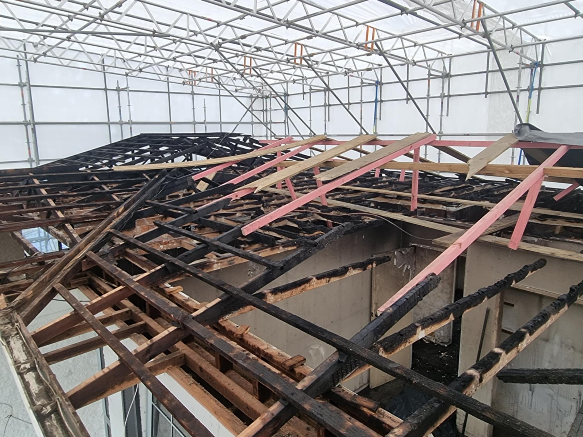 Fire‑damaged roof after asbestos roofing removal and full environmental cleanup completed by Hazard Pro asbestos removal specialists.